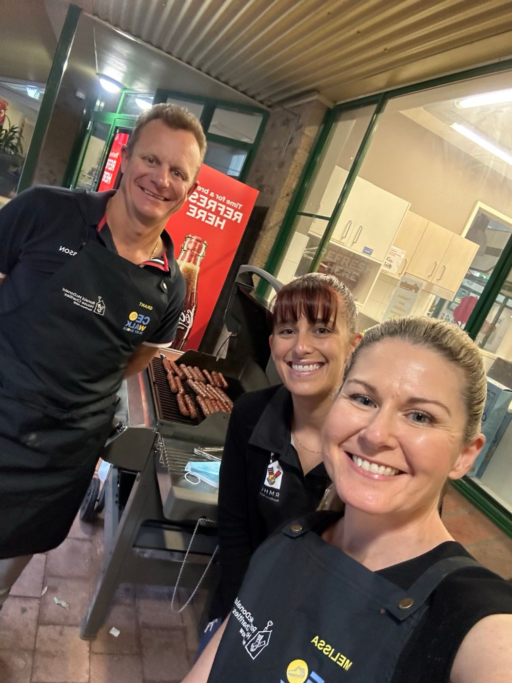 Melissa and fellow volunteers cooking a barbecue for Ronald McDonald House Charities