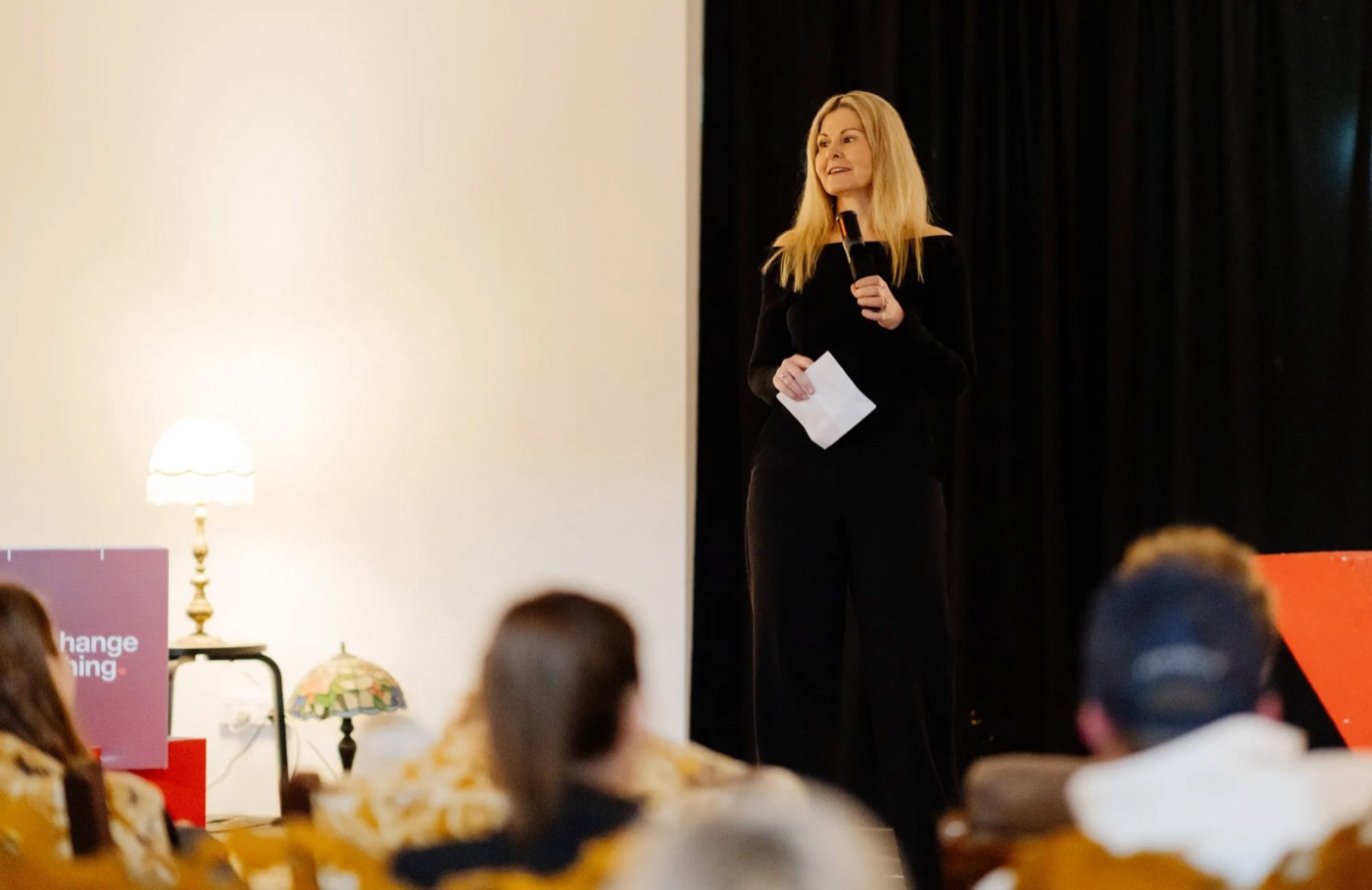 Melissa speaking on stage at TEDx Newy