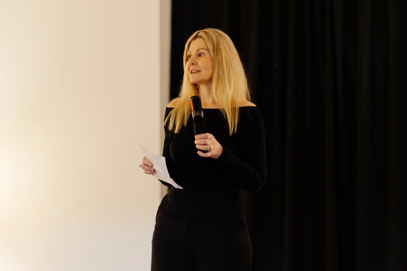 Melissa speaking with a microphone at TEDx Newy